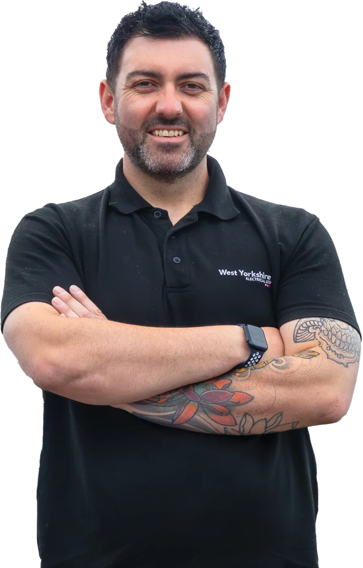 Jamie Grady, electrician, arms folded in a black West Yorkshire Electrical polo